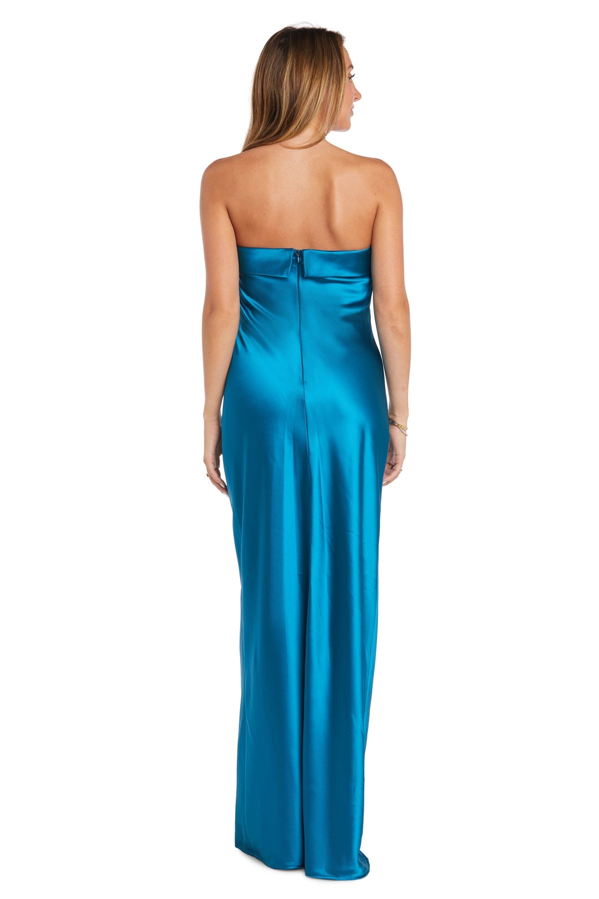 A woman in the Morgan 10219 Long Simple Satin Prom Dress, featuring a sheath silhouette and strapless design in floor-length blue satin, stands with her back to the camera against a plain white background.
